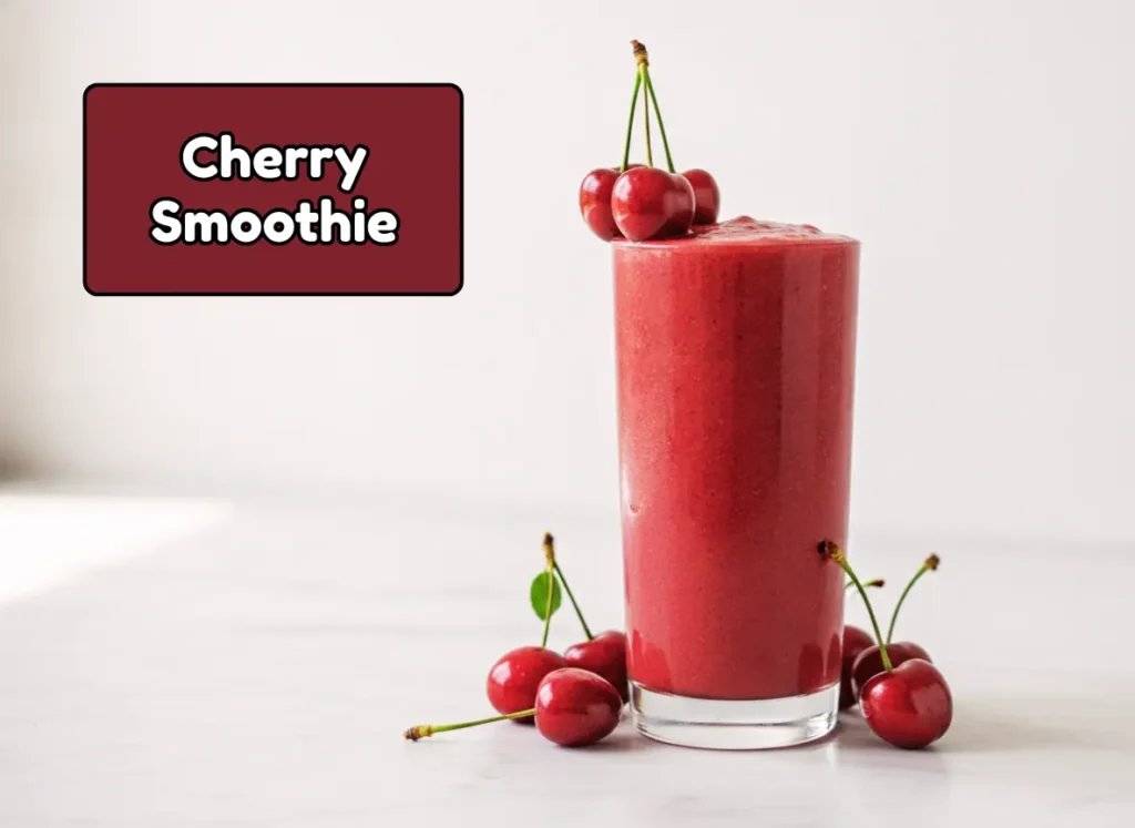 Creamy cherry smoothie in a tall glass garnished with fresh cherries — one of the best healthy smoothie ideas for antioxidants