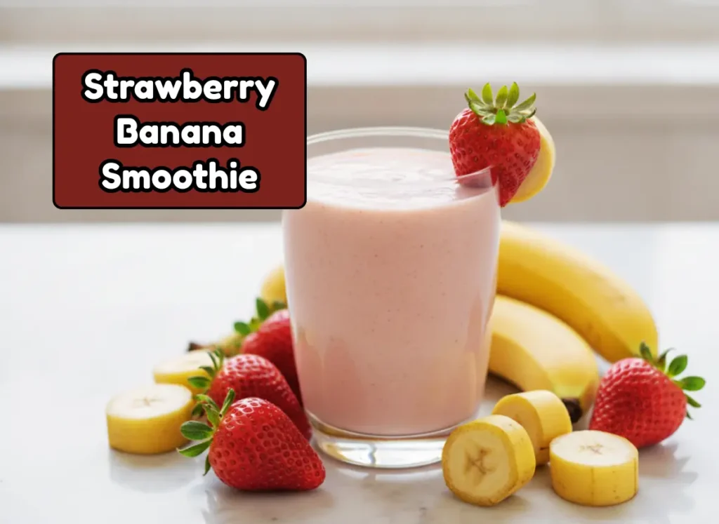 Classic thick strawberry banana smoothie in a clear glass with fresh strawberries — the easiest healthy smoothie recipe for beginners